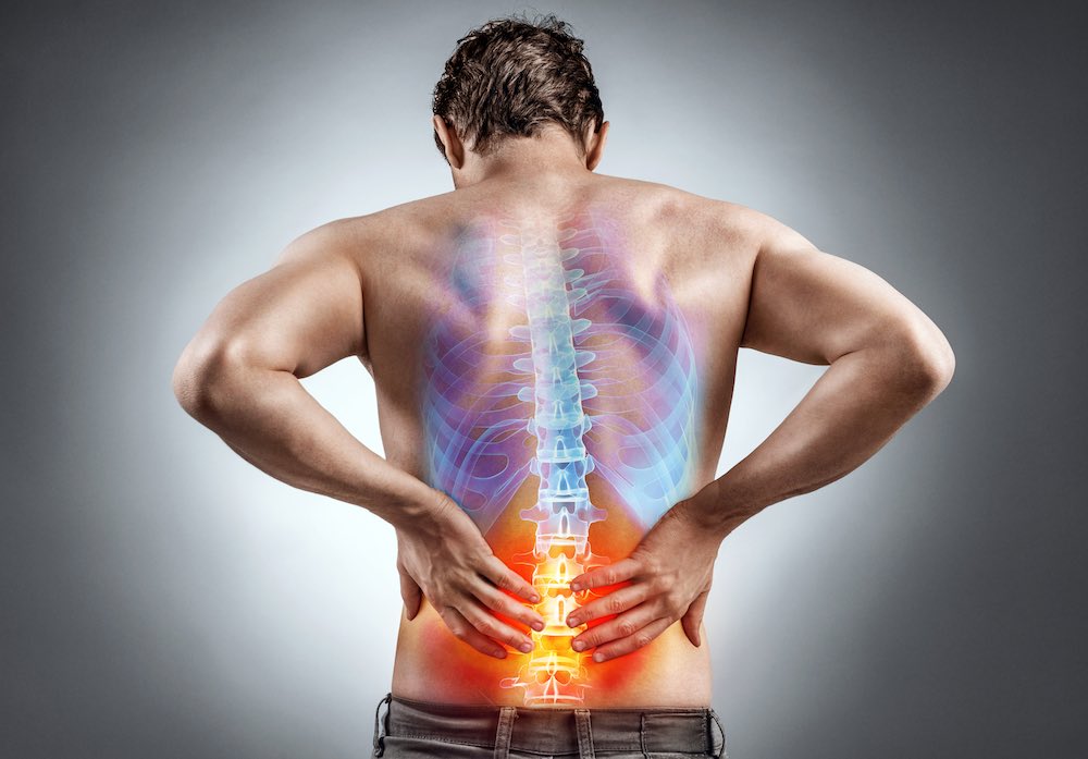 man holding lower back in pain
